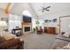 Inviting living room with cozy fireplace, vaulted ceiling, large windows, and open space perfect for gatherings at 10654 W Dumbarton Cir # A, Littleton, CO 80127