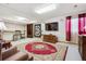 Spacious living room with a large TV, cozy seating, and stylish decor at 10654 W Dumbarton Cir # A, Littleton, CO 80127