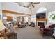 Bright living room features vaulted ceiling, fireplace, large windows, and a seamless flow to the dining area at 10654 W Dumbarton Cir # A, Littleton, CO 80127