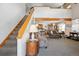 Spacious living room with vaulted ceilings, open floor plan, and a cozy staircase leading to the upper level at 10654 W Dumbarton Cir # A, Littleton, CO 80127