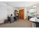 Functional home office with a large desk, ample storage, and natural light at 10654 W Dumbarton Cir # A, Littleton, CO 80127