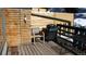 Outdoor patio area with a grill, chair, and wooden surroundings at 223 S Fuller Placer Rd # 4, Breckenridge, CO 80424