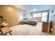 Comfortable bedroom with a wooden bench, large window and neutral colored walls at 223 S Fuller Placer Rd # 4, Breckenridge, CO 80424