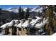 Exterior view showcasing snow covered roofs with scenic mountain views and beautiful trees at 223 S Fuller Placer Rd # 4, Breckenridge, CO 80424