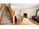 Inviting living area featuring comfortable seating, wood-burning stove, and staircase to upper level at 223 S Fuller Placer Rd # 4, Breckenridge, CO 80424