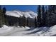 Snowy road winding through a mountain landscape with snow-covered trees, offering a scenic view at 223 S Fuller Placer Rd # 4, Breckenridge, CO 80424