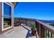 Rear deck featuring chairs and breathtaking views of the surrounding valley at 1295 Hy Vu Dr, Evergreen, CO 80439