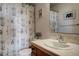 Well-lit bathroom boasts a vanity with a tiled countertop and backsplash plus a shower/tub combination at 1295 Hy Vu Dr, Evergreen, CO 80439