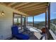 Expansive deck with mountain views, stylish seating, and a covered area for outdoor relaxation at 1295 Hy Vu Dr, Evergreen, CO 80439