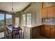 Cozy dining area with views, a stylish chandelier, and access to the balcony at 1295 Hy Vu Dr, Evergreen, CO 80439