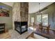 Cozy dining room features a stone fireplace, mountain views, and a dining table for delightful meals at 1295 Hy Vu Dr, Evergreen, CO 80439