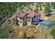 Stunning mountain home featuring a large driveway, tiered balconies, and incredible views at 1295 Hy Vu Dr, Evergreen, CO 80439