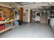 Spacious garage with ample storage, a work bench, and room for two cars and other equipment at 1295 Hy Vu Dr, Evergreen, CO 80439