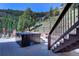 Private deck with a hot tub, offering stunning views and a serene outdoor experience with comfortable seating at 1295 Hy Vu Dr, Evergreen, CO 80439