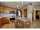 Well-equipped kitchen with an island, stainless steel appliances, and light wood cabinets at 1295 Hy Vu Dr, Evergreen, CO 80439