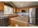 This bright kitchen is equipped with stainless steel appliances, lots of cabinets, and a central island sink at 1295 Hy Vu Dr, Evergreen, CO 80439