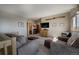 Inviting living room features cozy seating, a rustic entertainment center, and unique aviation-themed decor at 1295 Hy Vu Dr, Evergreen, CO 80439
