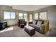 Spacious living room featuring comfortable seating, large windows with mountain views, and a wood-burning stove at 1295 Hy Vu Dr, Evergreen, CO 80439