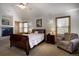 This main bedroom features a fireplace, wooden furniture, and plentiful windows with lots of natural light at 1295 Hy Vu Dr, Evergreen, CO 80439