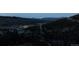 Serene night view showcasing the neighborhood nestled in the valley and mountain at 1295 Hy Vu Dr, Evergreen, CO 80439