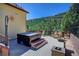 Relaxing outdoor spa area with a hot tub, comfortable seating, and scenic mountain views at 1295 Hy Vu Dr, Evergreen, CO 80439