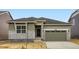 Charming home featuring stone accents, a well-manicured lawn and a two-car garage at 15274 Milwaukee St, Thornton, CO 80602