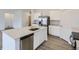 Modern kitchen with stainless steel appliances, quartz counters and a large island at 15274 Milwaukee St, Thornton, CO 80602