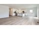 Open-concept living area with hardwood floors and modern kitchen, perfect for entertaining at 15274 Milwaukee St, Thornton, CO 80602