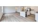 Spacious open-concept living area featuring hardwood floors and a modern kitchen at 15274 Milwaukee St, Thornton, CO 80602
