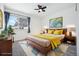 Virtually staged main bedroom with wood bed frame and yellow bedding at 5102 Williams Fork Trl # 109, Boulder, CO 80301