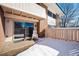 Back exterior view of home with snowy patio and sliding glass door at 5102 Williams Fork Trl # 109, Boulder, CO 80301