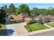 Beautiful aerial view of a home showcasing a large, paved driveway and lush landscaping at 8664 E Monmouth Pl, Denver, CO 80237