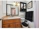 Bathroom with wooden vanity, granite countertop, vessel sink, and modern fixtures at 8664 E Monmouth Pl, Denver, CO 80237