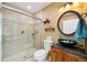 Stylish bathroom with glass-enclosed shower, unique vessel sink, and modern fixtures at 8664 E Monmouth Pl, Denver, CO 80237
