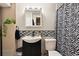 Modern bathroom featuring a black and white zebra striped shower curtain, sleek black fixtures, and decorative mosaic tile backsplash at 8664 E Monmouth Pl, Denver, CO 80237