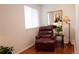 Cozy room with a comfy leather recliner, a small side table and a bright mirror at 8664 E Monmouth Pl, Denver, CO 80237