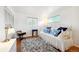 Bright bedroom with white walls and a decorative metal daybed with blue throw pillows at 8664 E Monmouth Pl, Denver, CO 80237