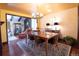Inviting dining room with hardwood floors, chandelier, and seamless flow into the living area at 8664 E Monmouth Pl, Denver, CO 80237