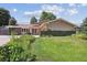 Inviting single-story home with a well-manicured lawn and attractive landscaping at 8664 E Monmouth Pl, Denver, CO 80237