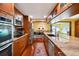 Beautiful kitchen with modern appliances, ample counter space, and an open layout to dining area at 8664 E Monmouth Pl, Denver, CO 80237
