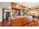Spacious kitchen with granite countertops, wood cabinets, and hardwood flooring at 8664 E Monmouth Pl, Denver, CO 80237