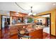 Modern kitchen with stainless steel appliances, custom cabinets, and a large central island at 8664 E Monmouth Pl, Denver, CO 80237