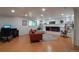 Cozy living room with wood-look floors, a fireplace, and built-in bookshelves at 8664 E Monmouth Pl, Denver, CO 80237