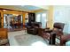 Inviting living room features tile floors, comfortable seating, and an open layout to the dining area at 8664 E Monmouth Pl, Denver, CO 80237