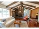 Cozy living room featuring wood floors, stone fireplace, and beautiful natural light at 8664 E Monmouth Pl, Denver, CO 80237