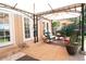 Relaxing covered patio with stone pavers, comfortable wicker furniture, and outdoor dining area, perfect for enjoying outdoor living at 8664 E Monmouth Pl, Denver, CO 80237