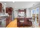 Modern kitchen with stainless steel appliances, wood cabinets, and a central island at 892 Macaw St, Brighton, CO 80601