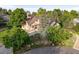 Scenic aerial view of a home nestled among mature trees and well-landscaped grounds at 6524 Surry Pl, Parker, CO 80134