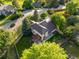 Aerial view of the backyard, showcasing a pergola-covered patio, lush lawn, and landscaped garden beds in a fenced yard at 6524 Surry Pl, Parker, CO 80134
