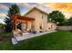 Backyard view showcasing the wooden pergola covered patio, manicured lawn, and lush landscaping at 6524 Surry Pl, Parker, CO 80134